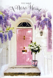 A romantic doorway scene in Hornsey captures the tender excitement of arriving at a new home, framed entirely in soft pastels and abundant blooms. The front door, painted a soothing, candy-like pink, stands at the heart of the composition, bordered by clean white walls that mirror the modest charm of nearby streets off Hornsey High Street. Above and around the frame, wisteria tumbles gracefully in cascades of lavender and pale purple, each hanging cluster forming a perfumed canopy that makes the entrance feel sheltered and almost secret. Below this curtain of blossoms, a neat concrete or stone step leads to a grey metal bucket placed carefully at the threshold, as if just set down after a local delivery. The bucket brims with lush white and cream roses, their rounded heads close together in a plush, cloud-like cluster, offset by fresh green foliage that adds gentle contrast and a sense of garden freshness. A blush-pink ribbon is tied around the bucket's base, its loose ends resting lightly against the metal and subtly mirroring the pink of the door. Soft daylight filters through the wisteria, throwing dappled shadows and highlights that give depth to the scene and suggest the quiet warmth of a spring afternoon. The overall mood is one of quiet joy and hopeful anticipation: a housewarming bouquet waiting patiently on the doorstep, ready to welcome its new owners and infuse their fresh start with beauty, tenderness, and the comforting feeling of belonging in this little corner of north London.